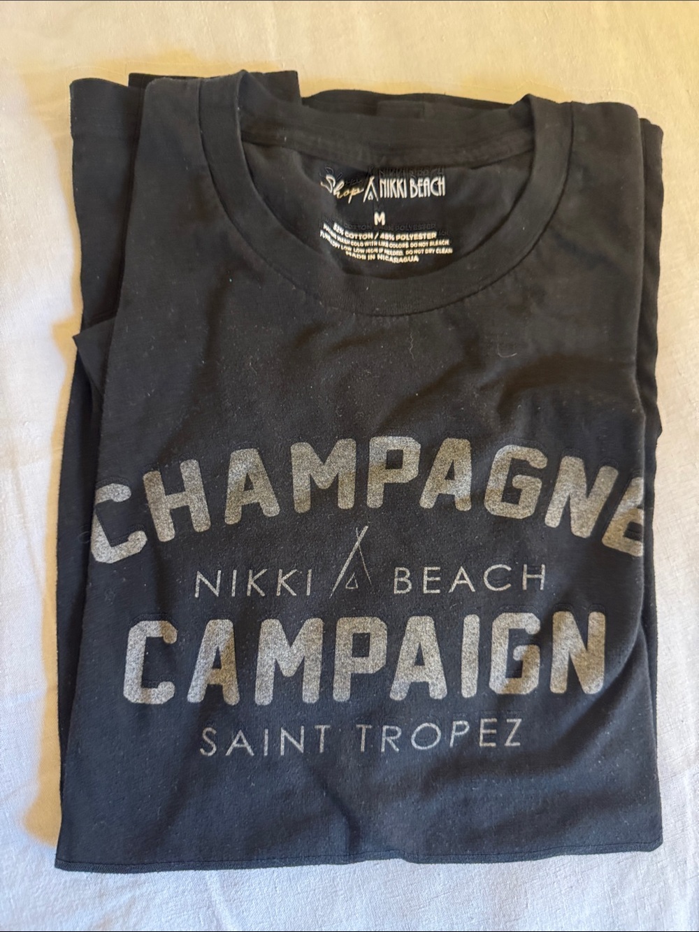 Nikki Beach Men's Short Sleeve Graphic Tee in Black - Champagne Campaign